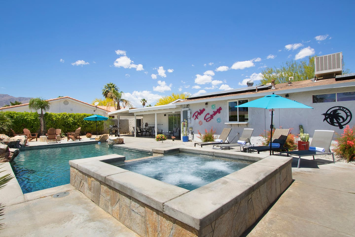 Enjoy sunny Palm Springs in a big backyard with waterfalls, hot tub, pool and fire pit! 