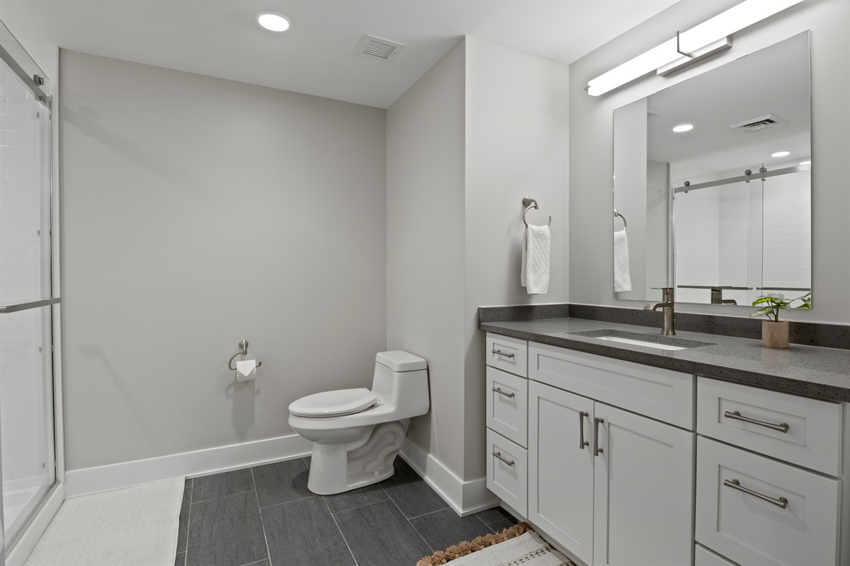 Spacious modern bathroom with sleek finishes, walk-in shower, and calming neutral tones — perfect for unwinding in style.