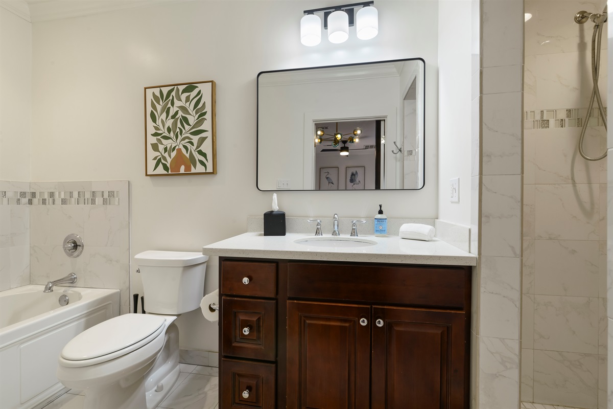 Full Bathroom of the Shorty Guest House with Tub and Walk-In Shower