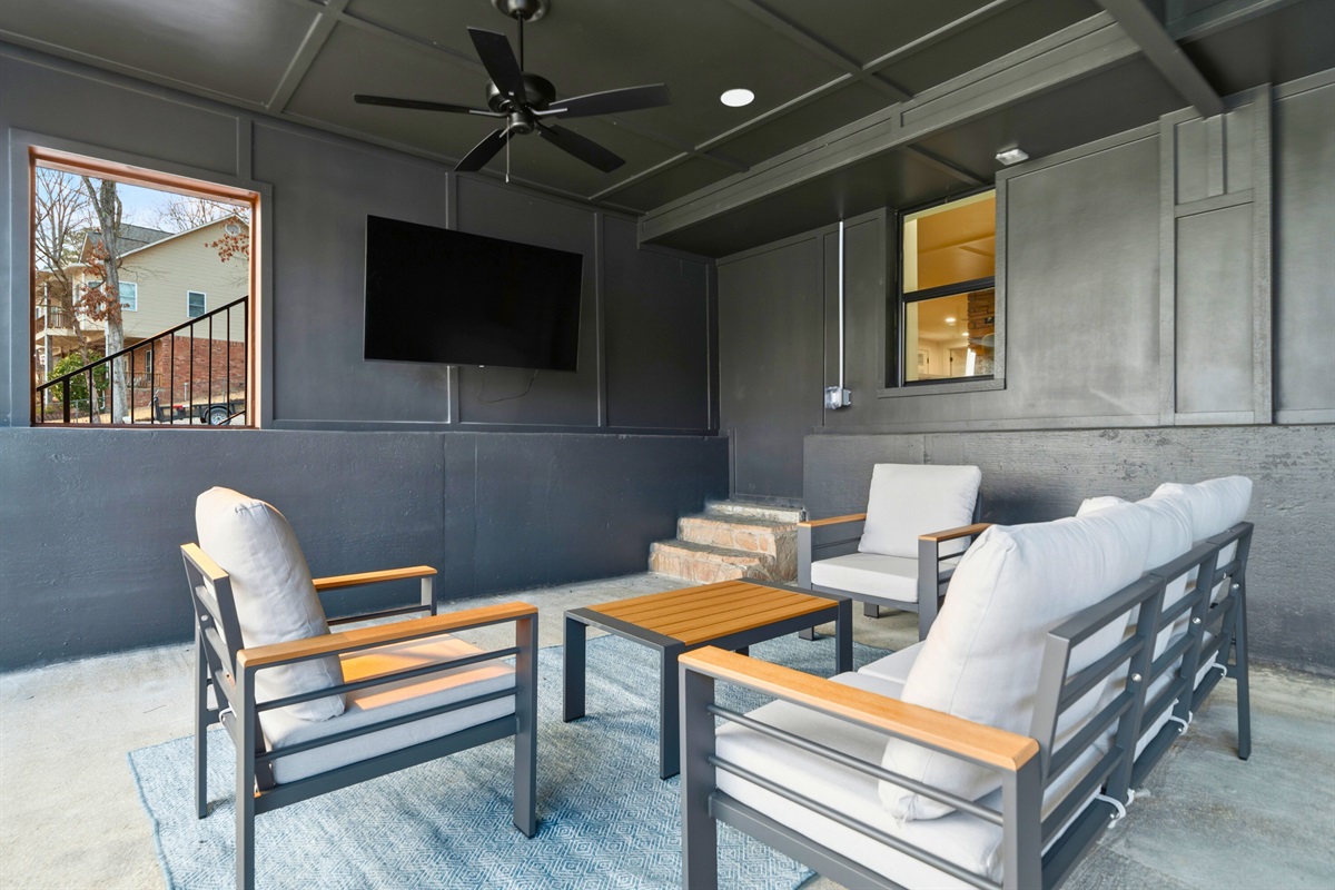 The outdoor lounge creates a comfortable gathering area where guests can relax while enjoying the breeze and lake views.