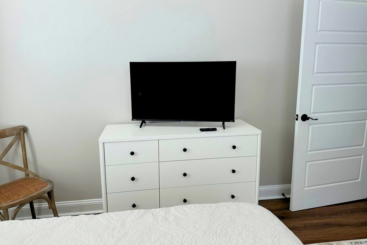 Second bedroom with its own Smart TV and dresser storage