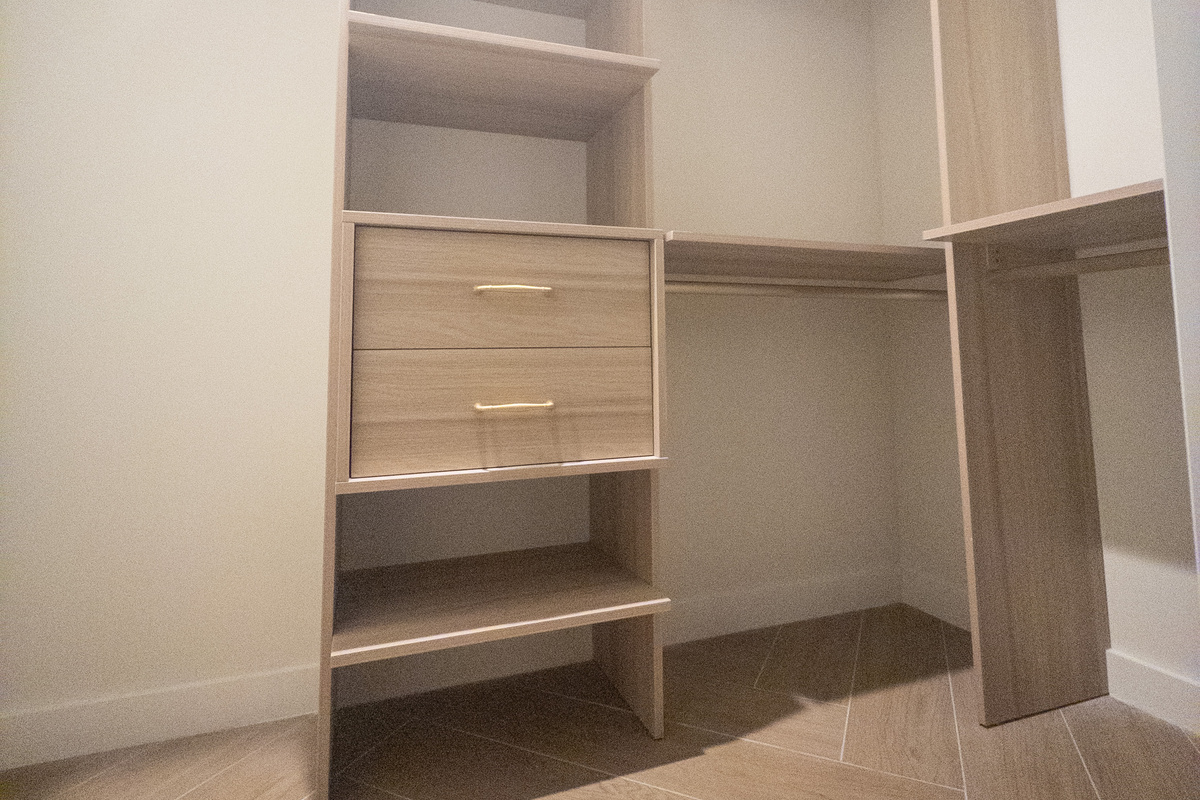 Custom walk-in closet with built-in shelving - room for every suitcase.