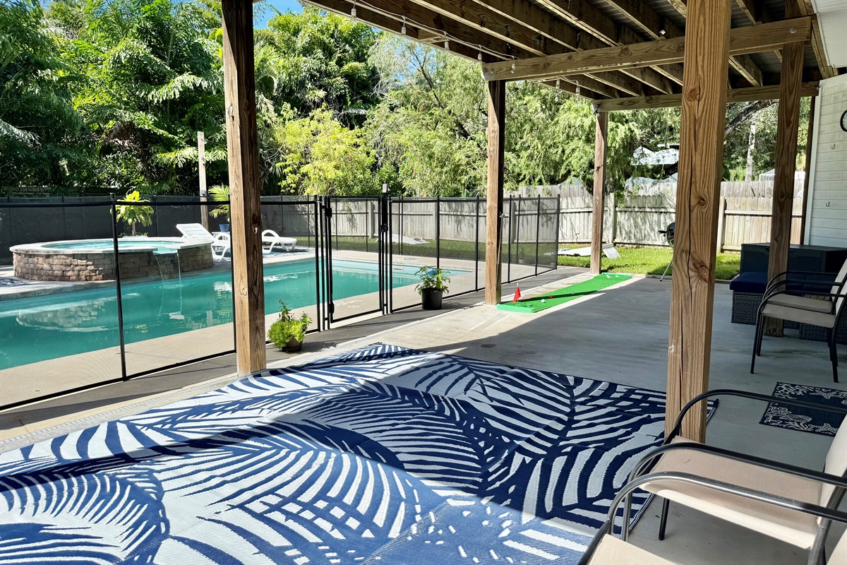 Relax under the covered deck with plenty of seating and views of the sparkling pool and spa.