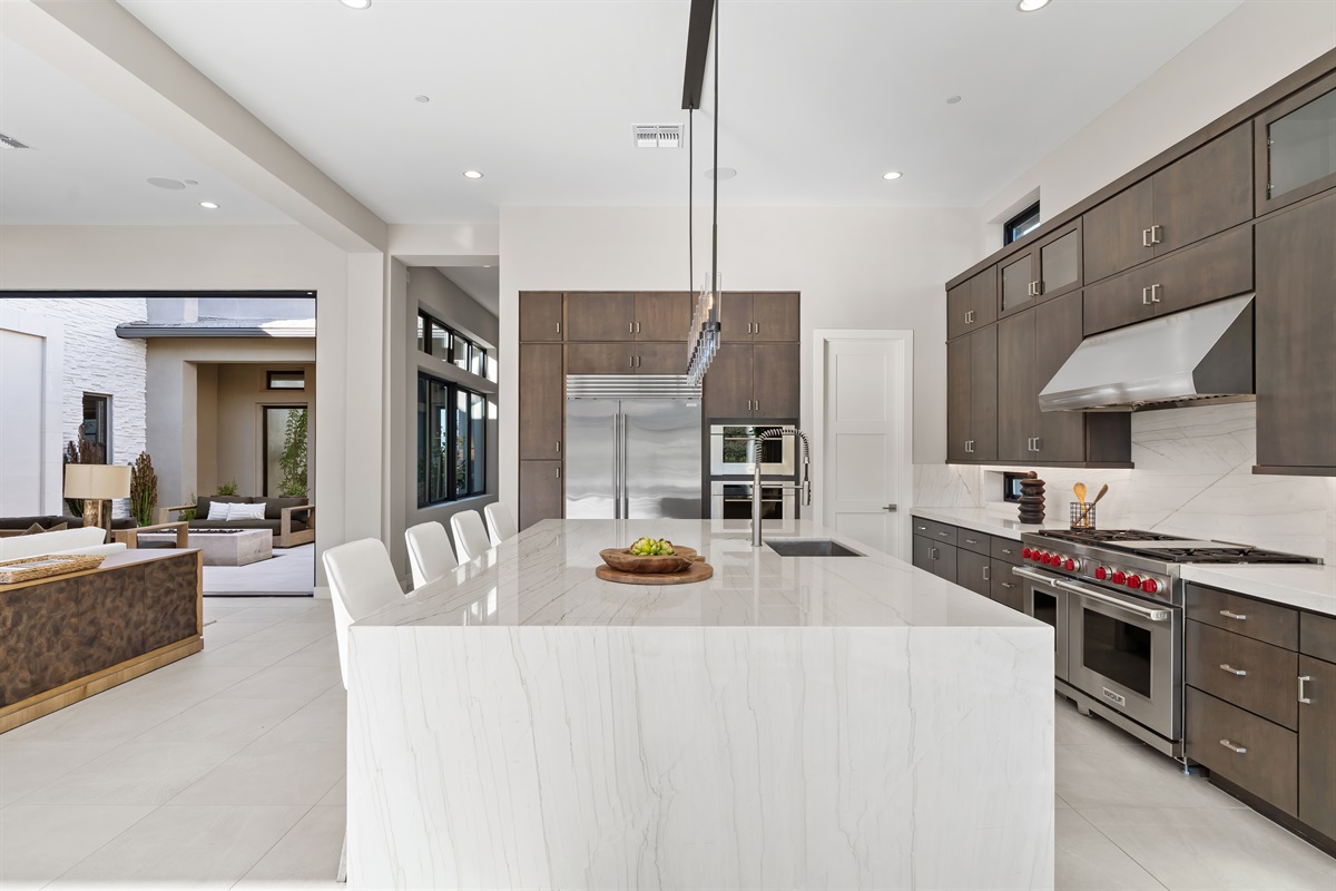 Gourmet Kitchen: Chef-grade Wolf & Sub-Zero appliances anchored by stunning quartzite countertops.  a