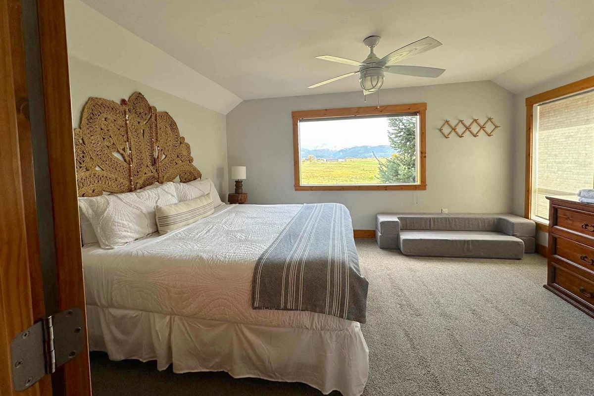 With a king bed and picture windows, you'll love waking up in this spacious primary bedroom.