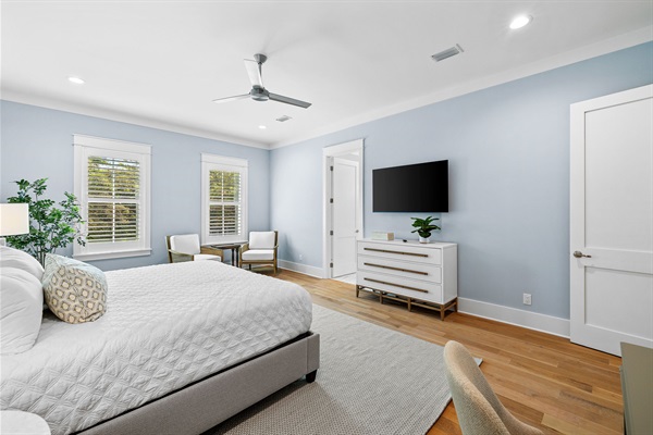 Large primary bedroom with seating and work desk