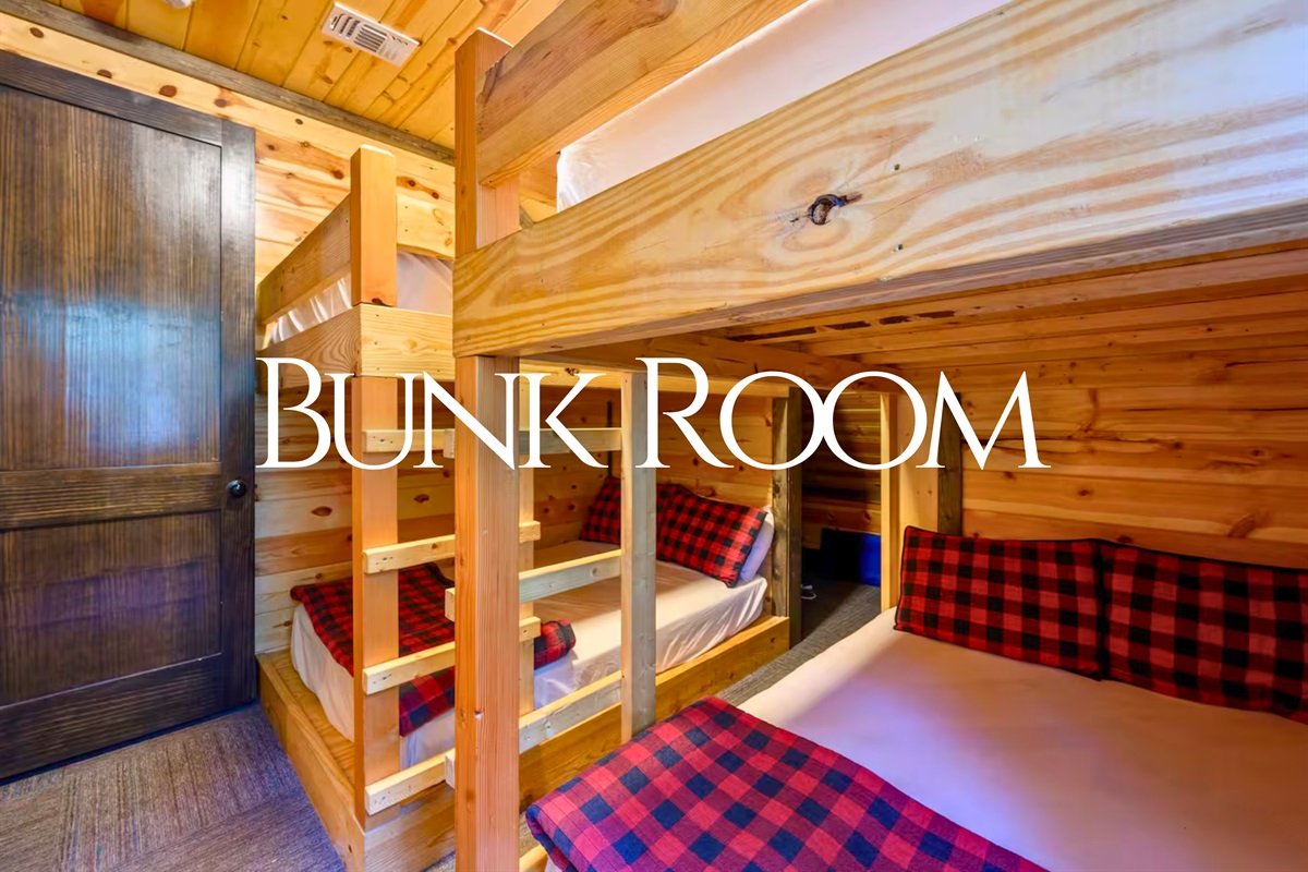 The bunkroom brings the fun with four double beds, cozy plaid bedding, and plenty of space for group adventures.