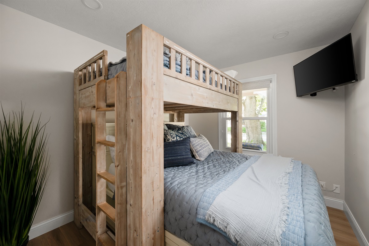 Bedroom #3 features a spacious full over queen bunk bed setup, perfect for kids, friends, or extra guests traveling together.
