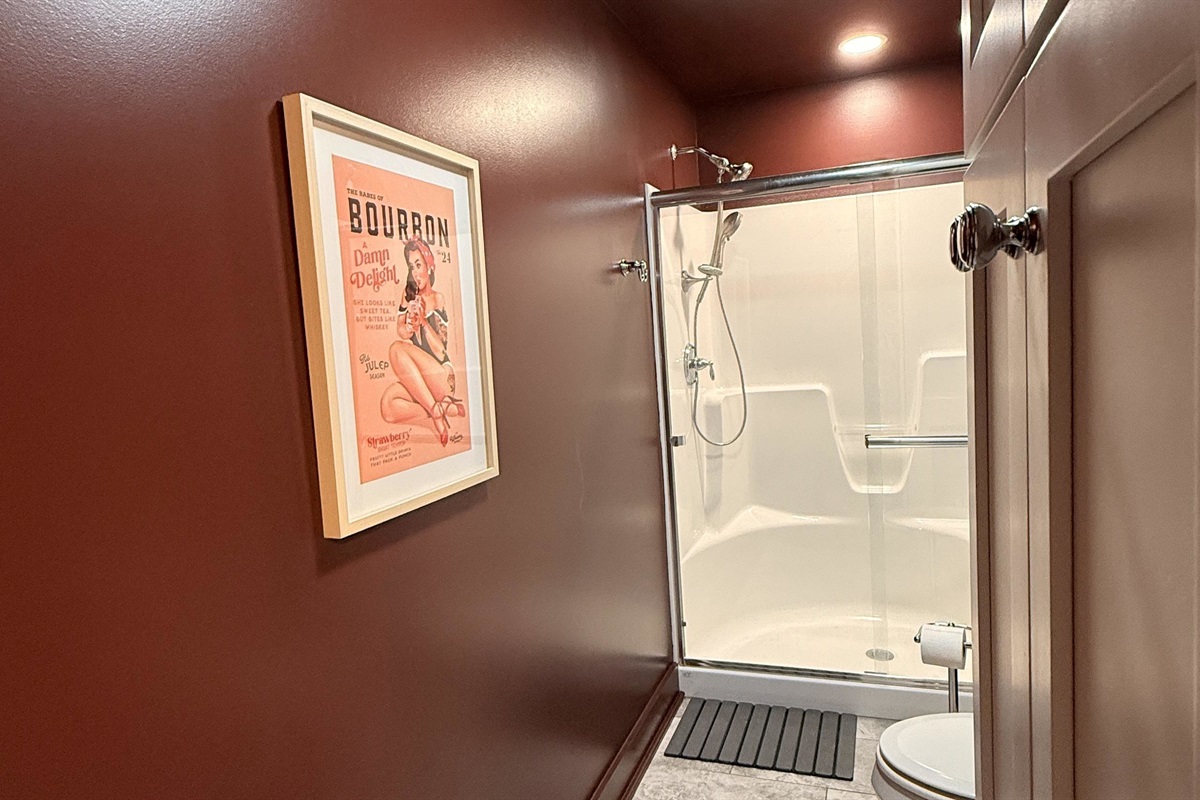 Playful charm meets polished design — a nod to bourbon’s bold spirit and timeless allure. This shared bathroom balances function and flair, offering guests a stylish space to refresh between evenings of laughter and late-night stories.