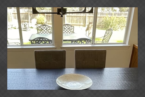 Breakfast area and adjoining kitchen  look out to backyard.  One of three dining areas, the breakfast area seats eight.  