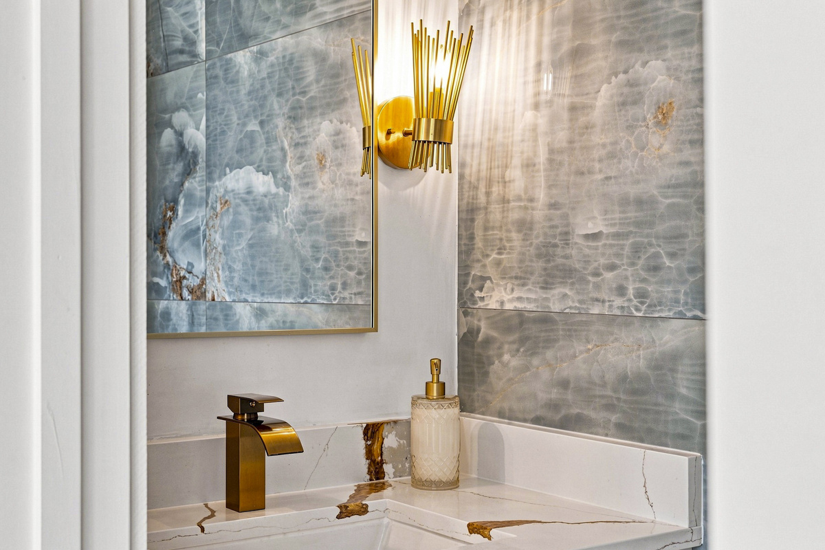 Experience luxury with stunning marble and chic gold accents!