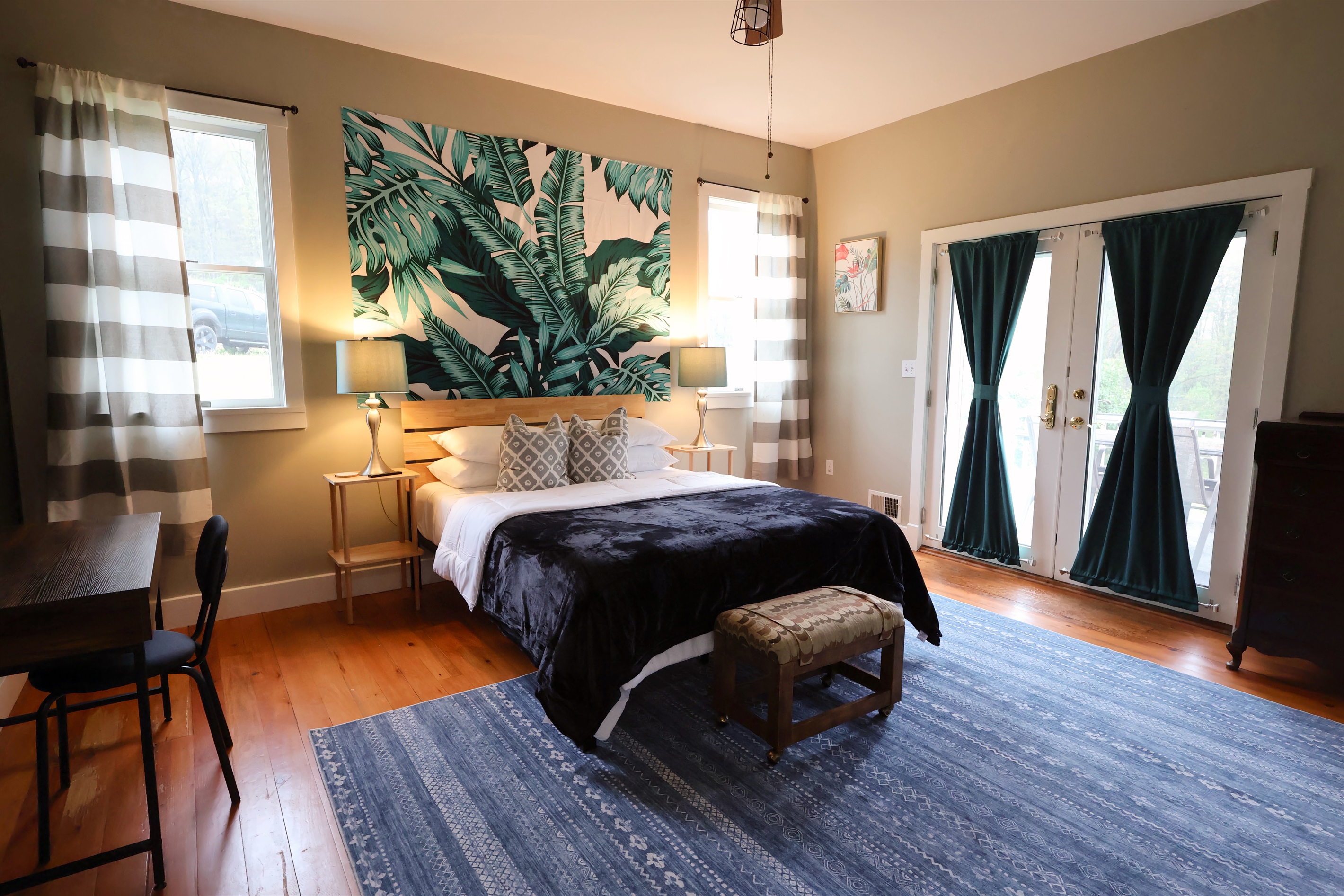Main floor bedroom, queen bed, with french door access to patio