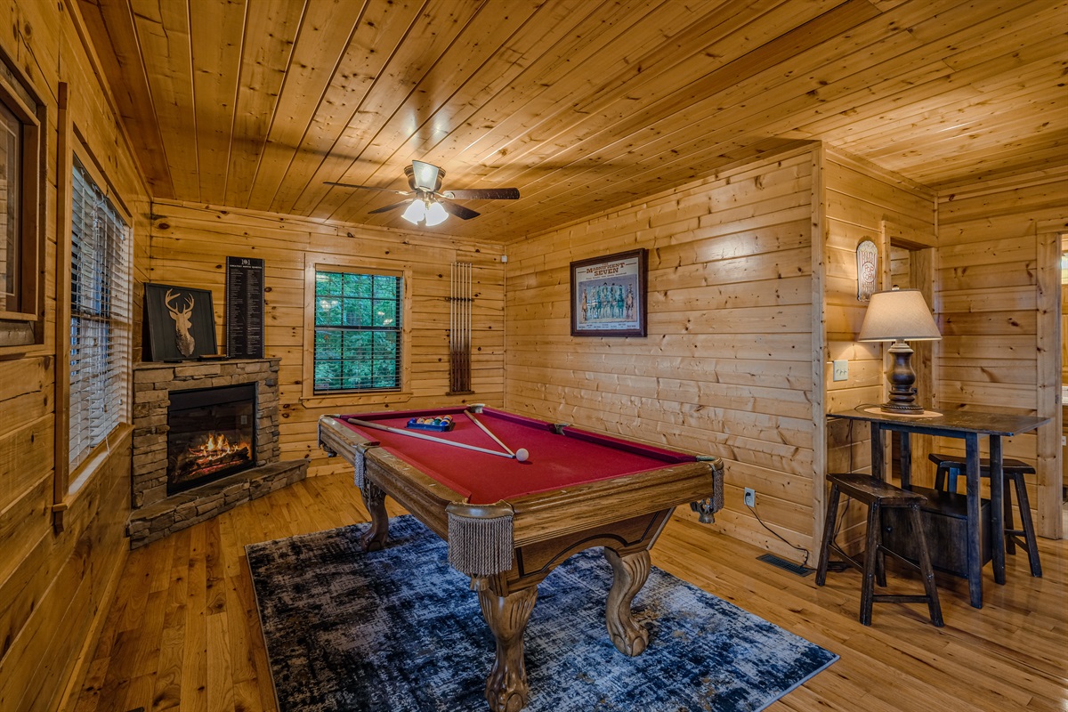 Game room with pool table and electric fireplace