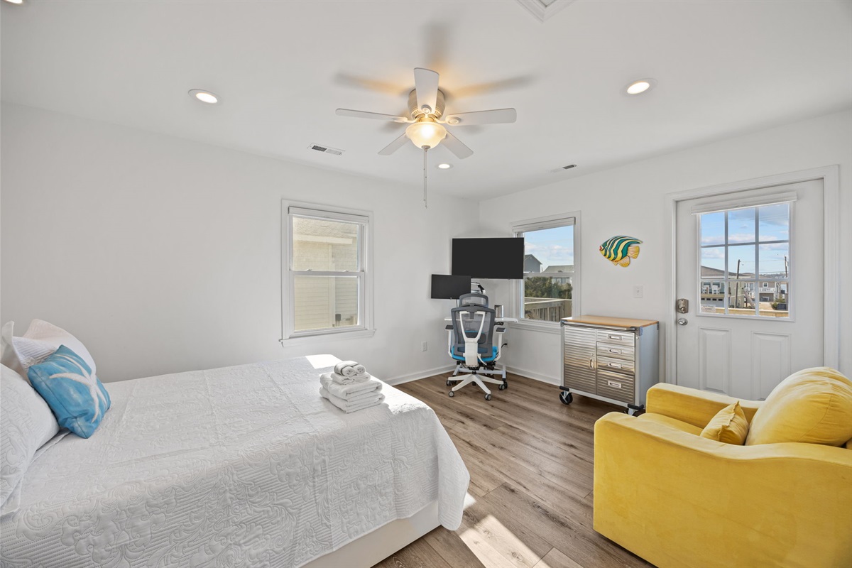 Spacious master bedroom with a queen bed and plenty of natural light