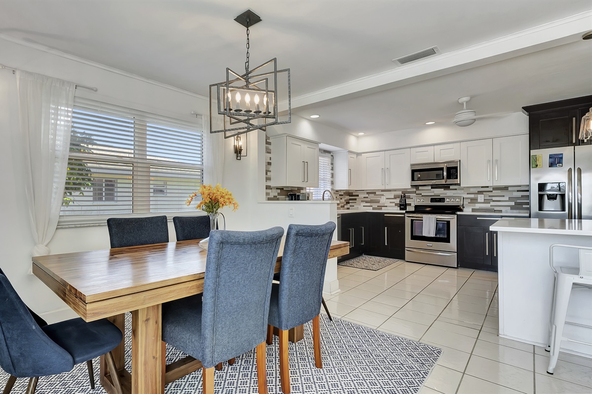 The dining table is conveniently placed next to the kitchen