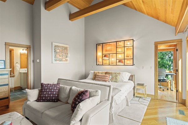 BR1: Primary bedroom on main level with king bed, seating area, gas fireplace