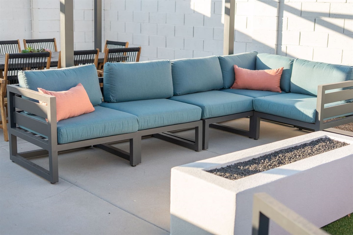 Plush sectional with accent pillows, perfect for gathering around the firepit.