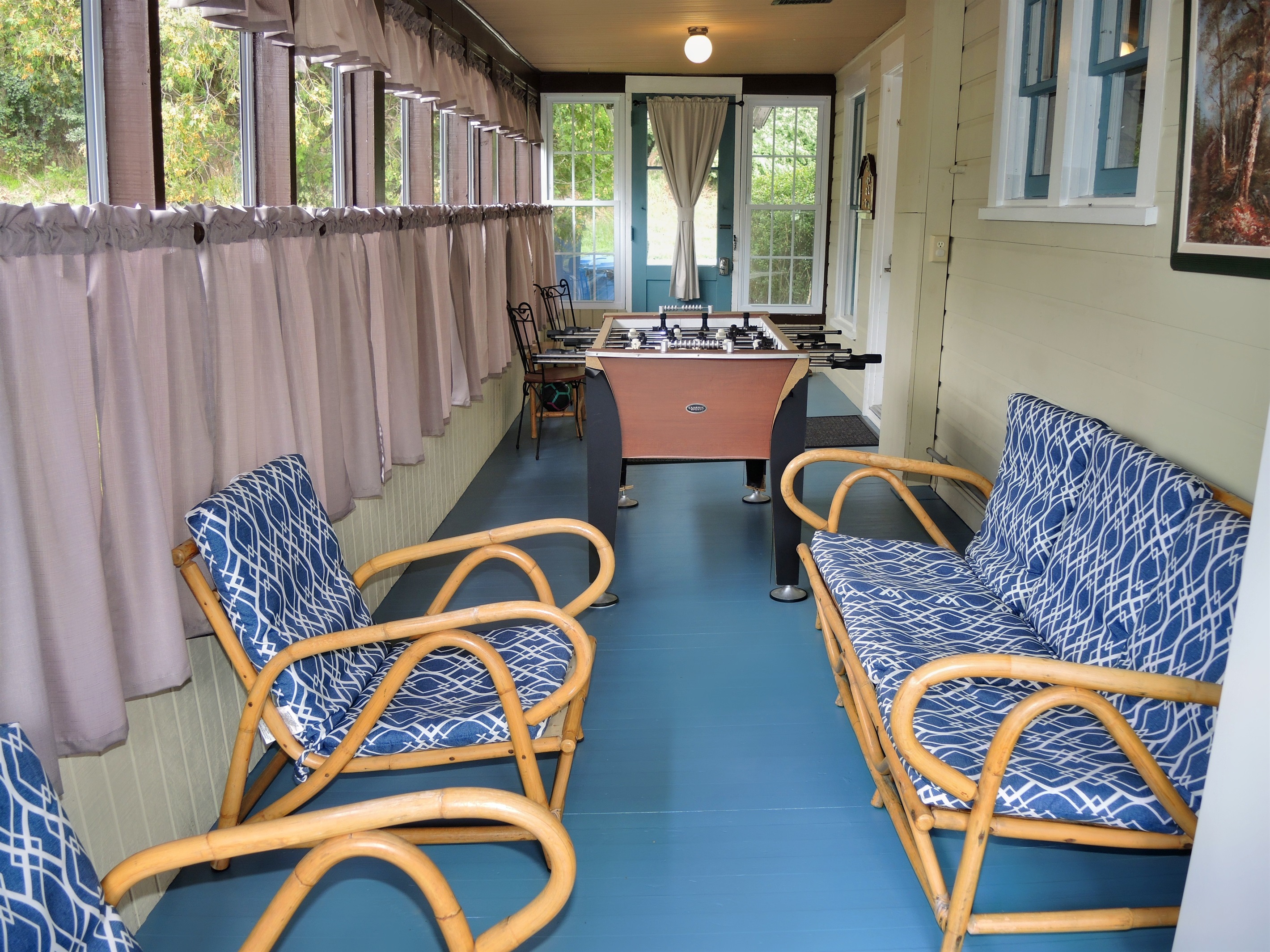 Enclosed porch with seating.