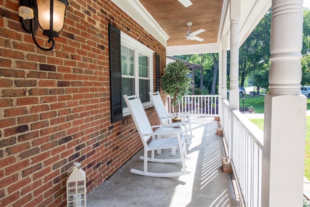 A timeless front porch framed by tall trees and fresh air — perfect for rocking chairs, conversation, and peaceful birdwatching.  Smoking is allowed here 
