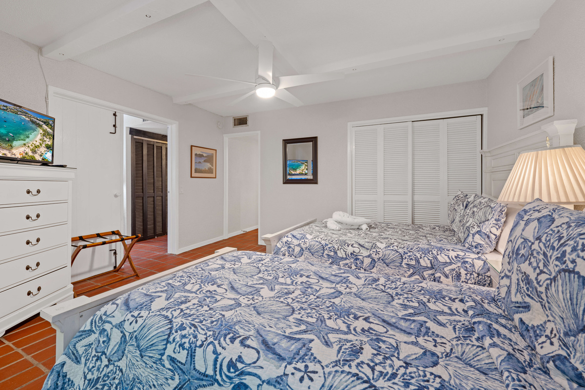 Comfortable guest bedroom with two beds, perfect for family or friends.