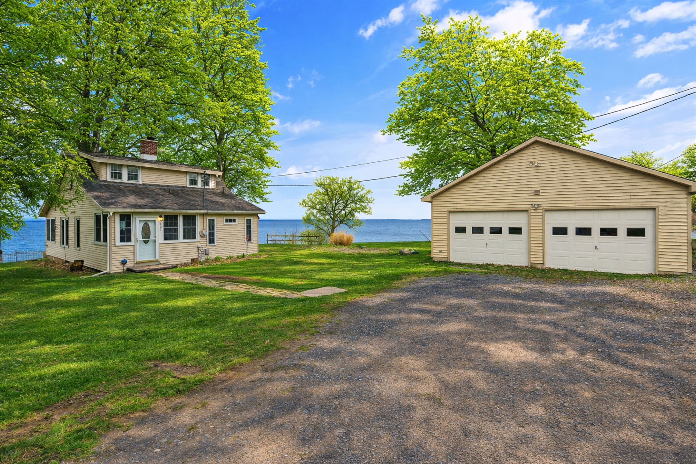 Ample parking space and a detached garage just steps from the water’s edge.