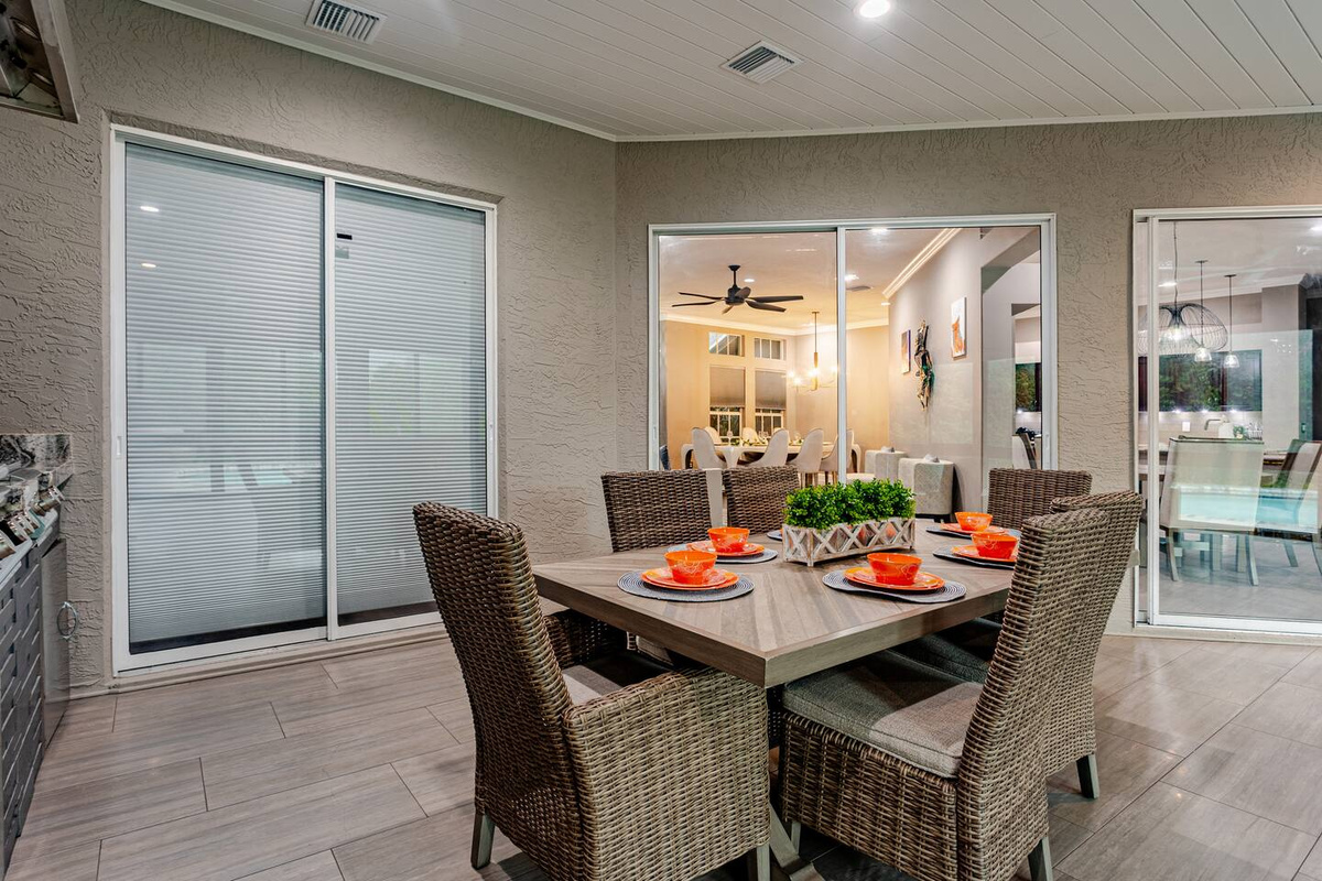 Bright and elegant sunroom featuring a stylish dining table and comfortable chairs, creating a welcoming space for family meals, morning coffee, and relaxed gatherings.

