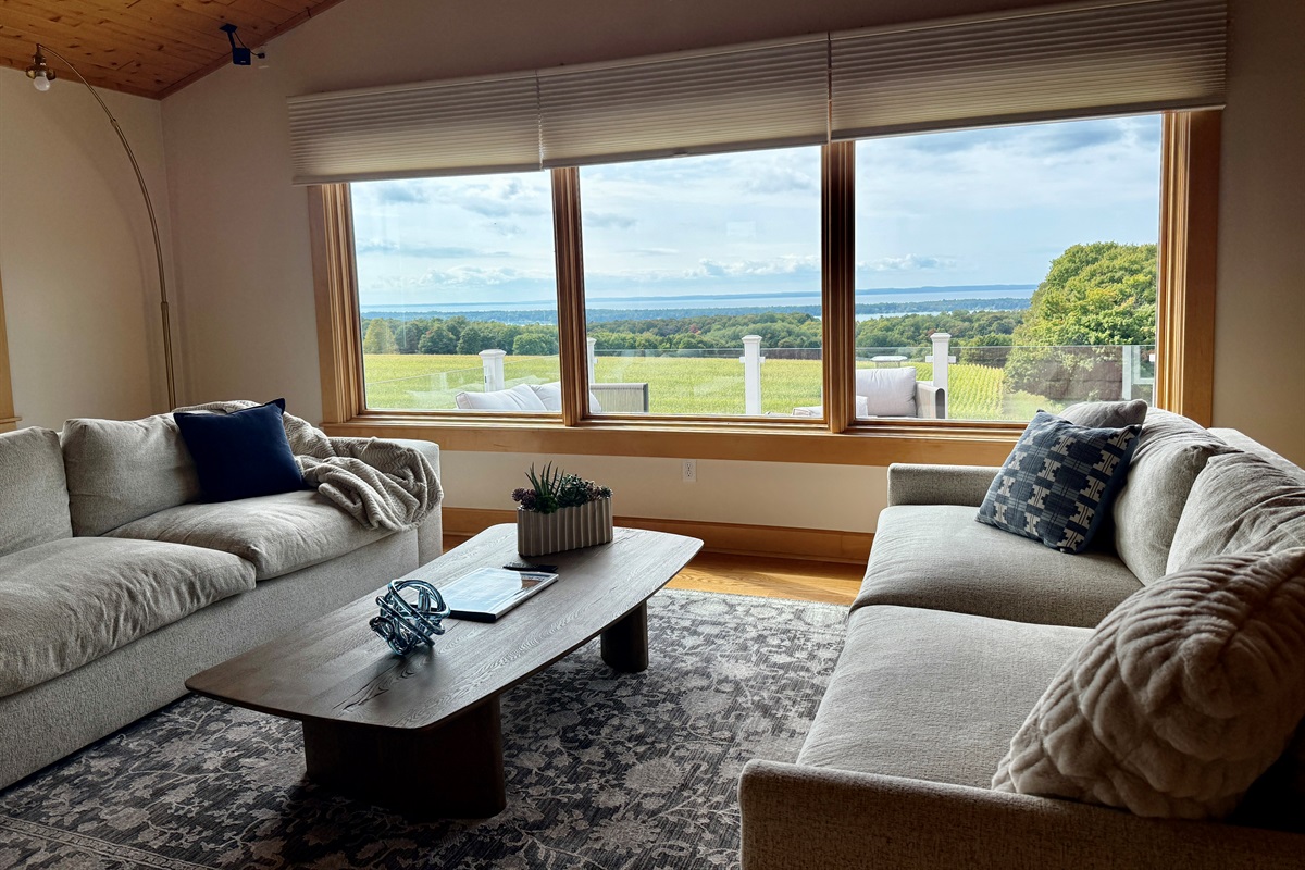 Relax in the oversize sofas in the living room with stunning panoramic views of Torch Lake, Grand Traverse Bay, Old Mission Peninsula and the Leelanau Peninsula.