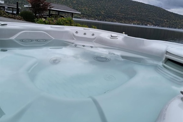 Soak in the hot tub while enjoying the views of the lake