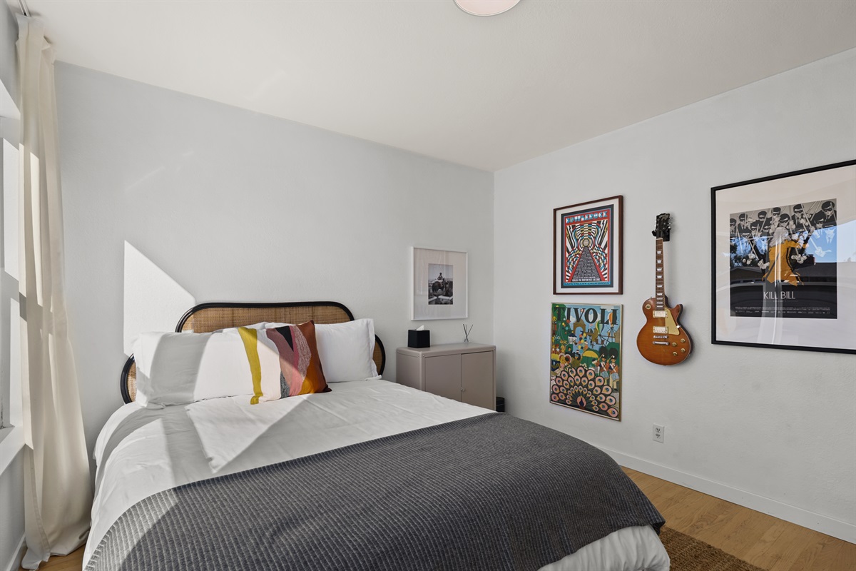 Inviting guest bedroom with a cozy queen bed, soft linens, and a peaceful atmosphere for a restful night's sleep.