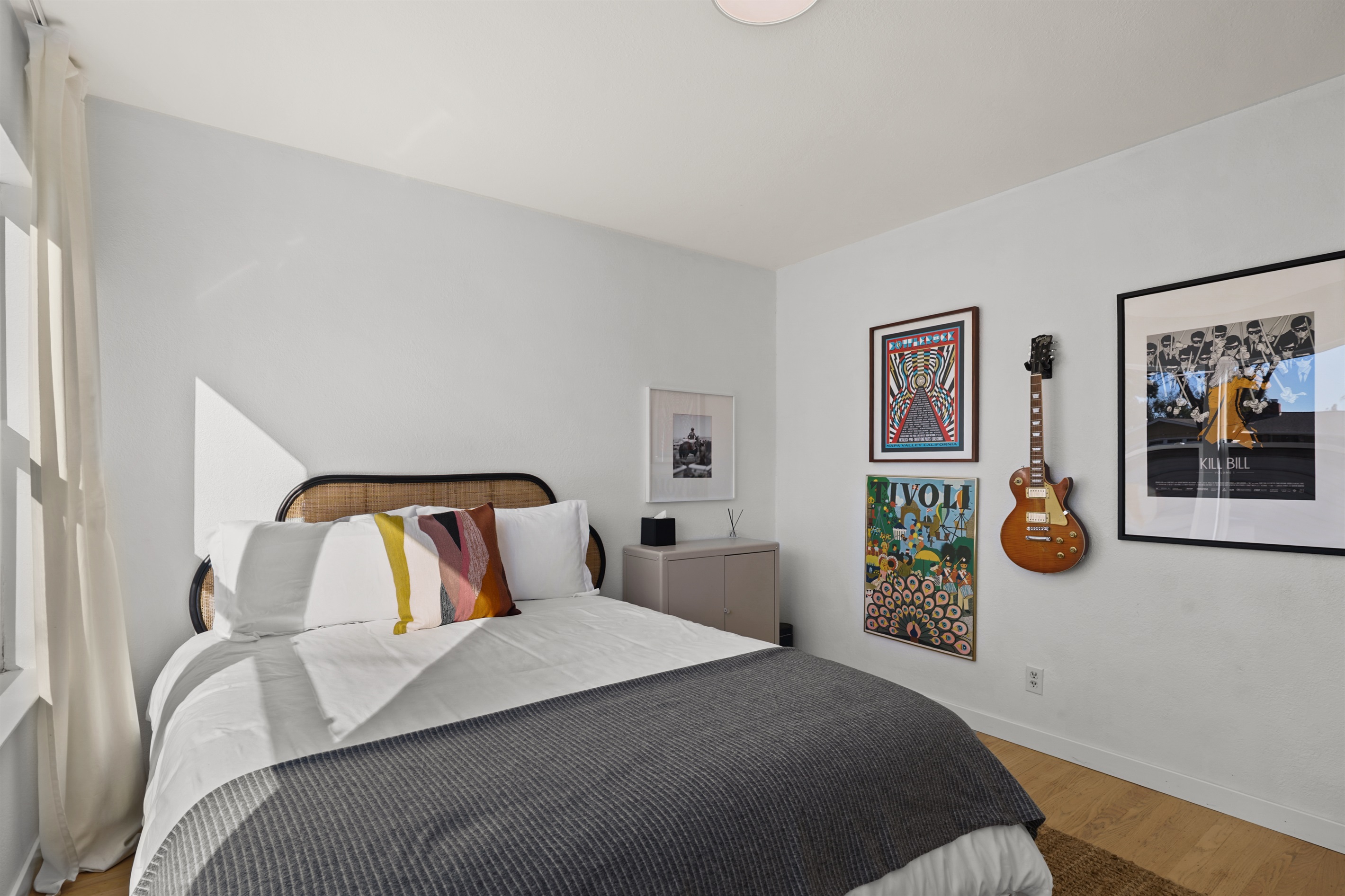 Inviting guest bedroom with a cozy queen bed, soft linens, and a peaceful atmosphere for a restful night's sleep.