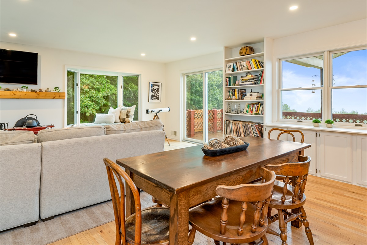 Dine with a view in this thoughtfully designed space featuring a wood dining table, built-ins, and sliding doors to the deck.
