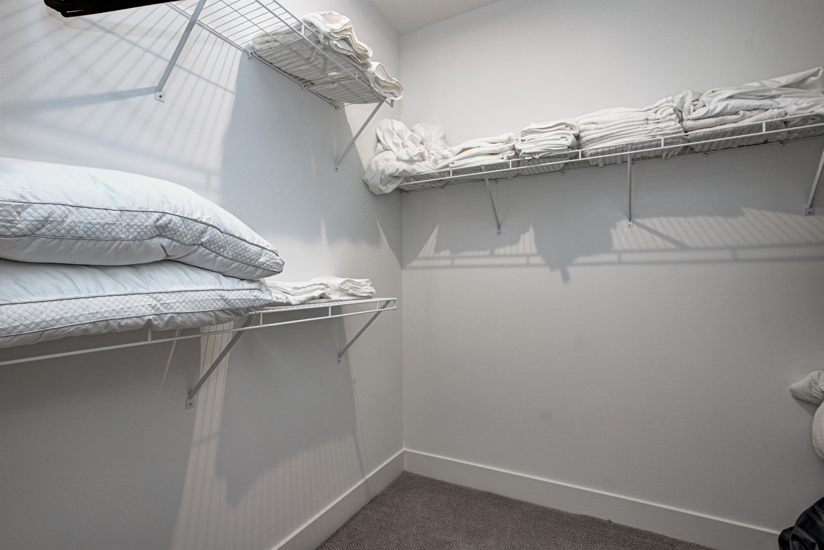 Relax in the serene master bedroom featuring a comfortable king-size bed, soft linens, and cozy pillows. Includes nightstands, lamps, walk-in closet, and full-length mirror for added comfort. 