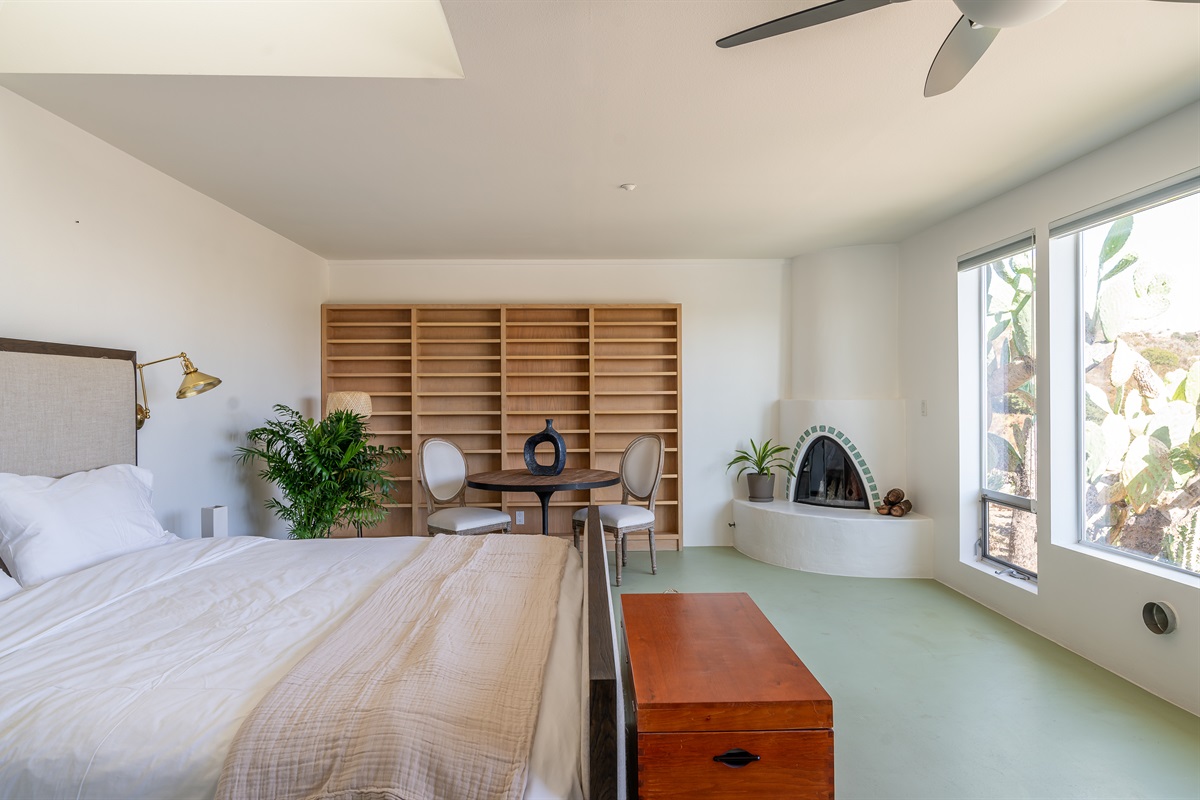 Kiva fireplace and bookshelves in the back wall