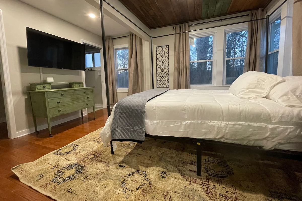 Master bedroom with private bathroom. Open windows to check out the quiet outdoors