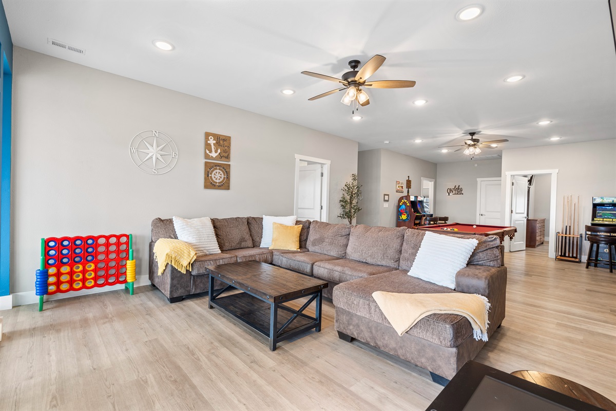 Enjoy the Upper level living room with plenty of seating, pool table and arcade games