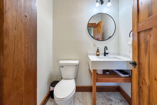 Half bath by the laundry area and indoor pickleball court.