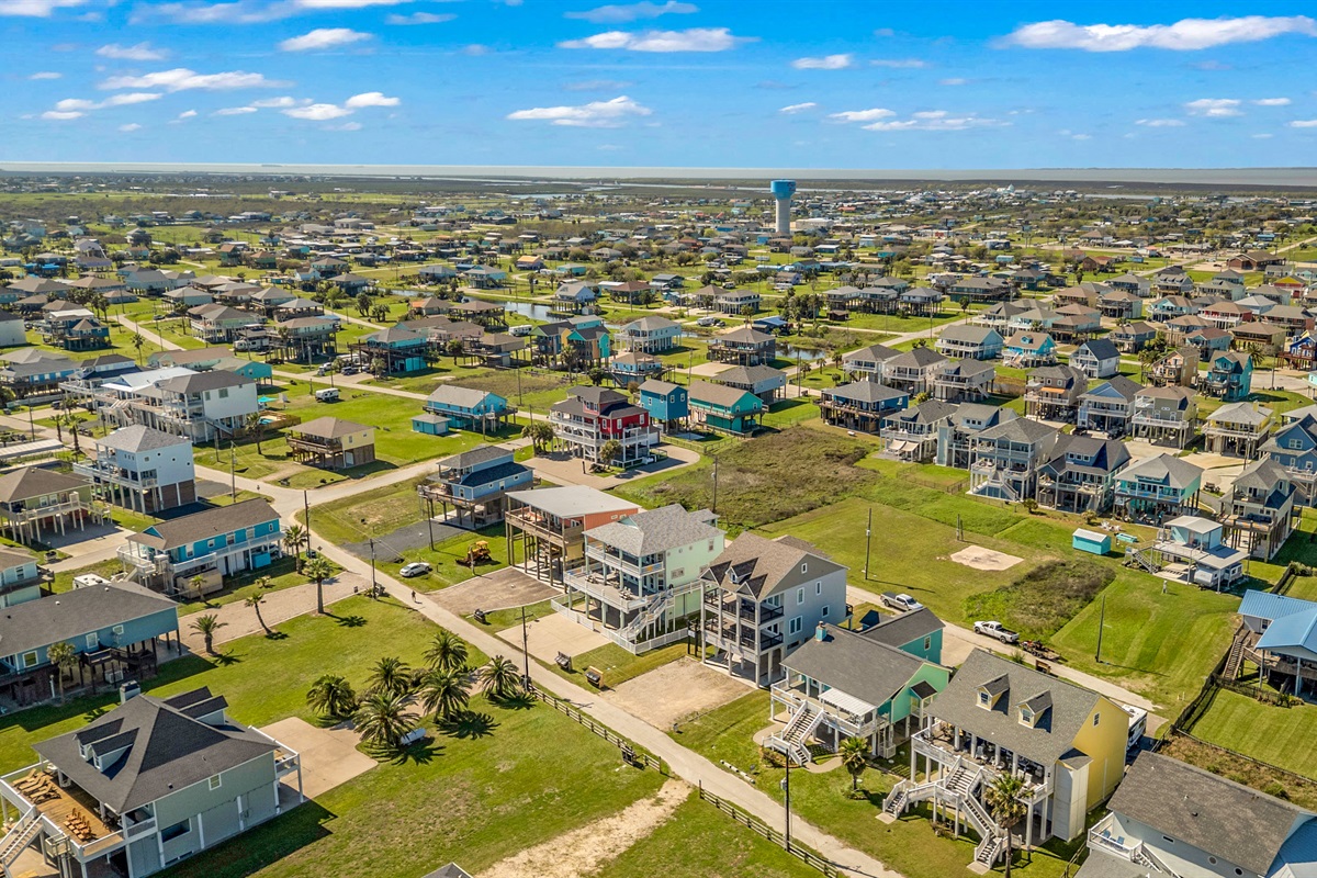 Costa Cristal Exterior: From the sky, the estate unfolds like a masterpiece, grand homes, pristine grounds, and winding paths perfectly blending luxury and nature. The aerial perspective captures the scale and elegance of the entire property.