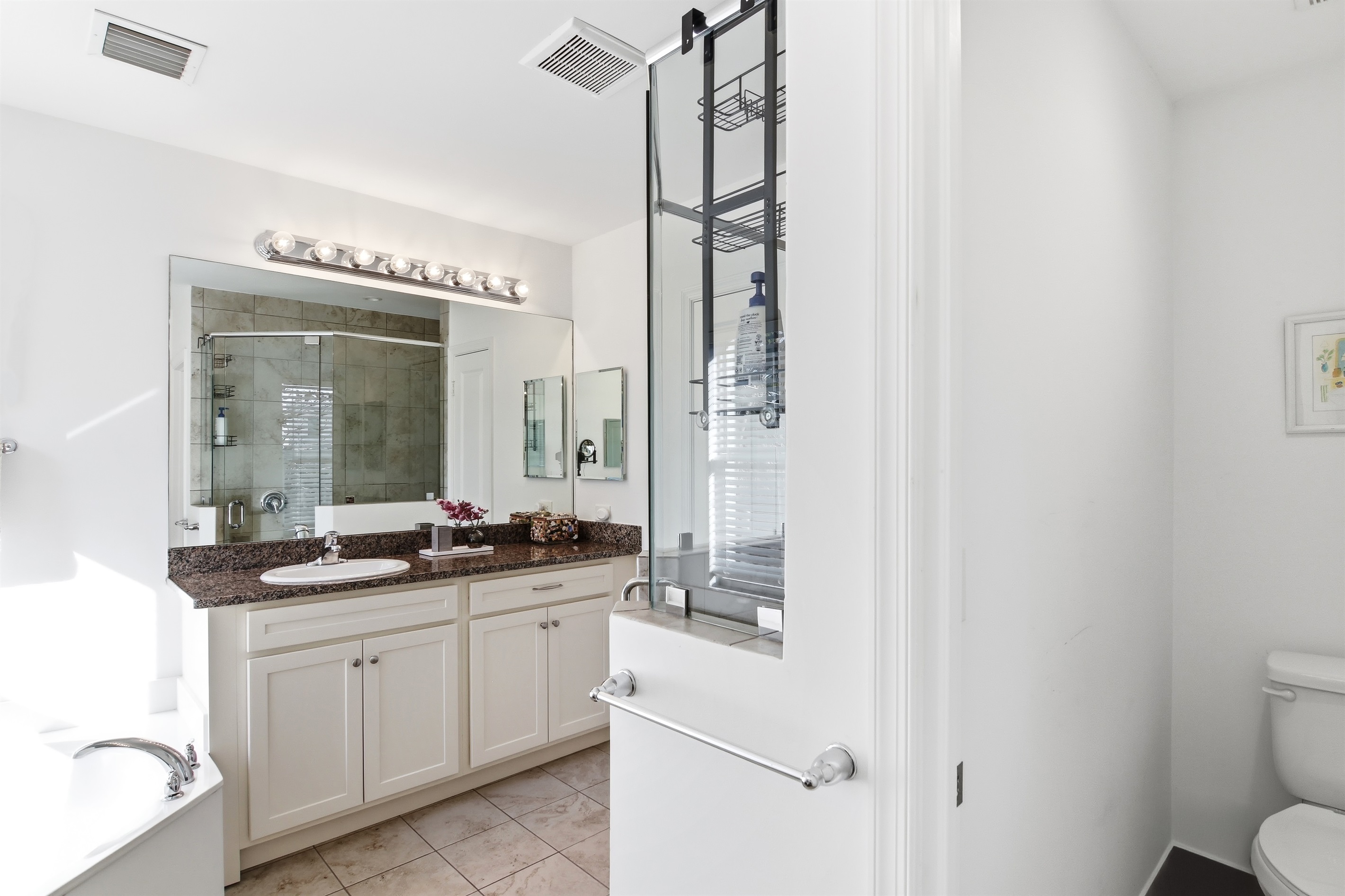 Primary en-suite, double vanity, stand up shower, separate soaking tub, private toilet room