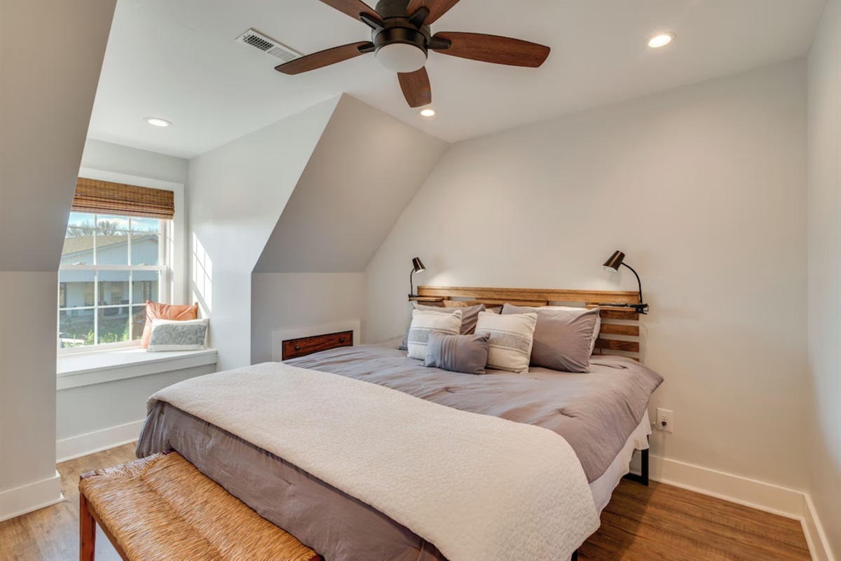 Bedroom with ceiling fan and king bed
