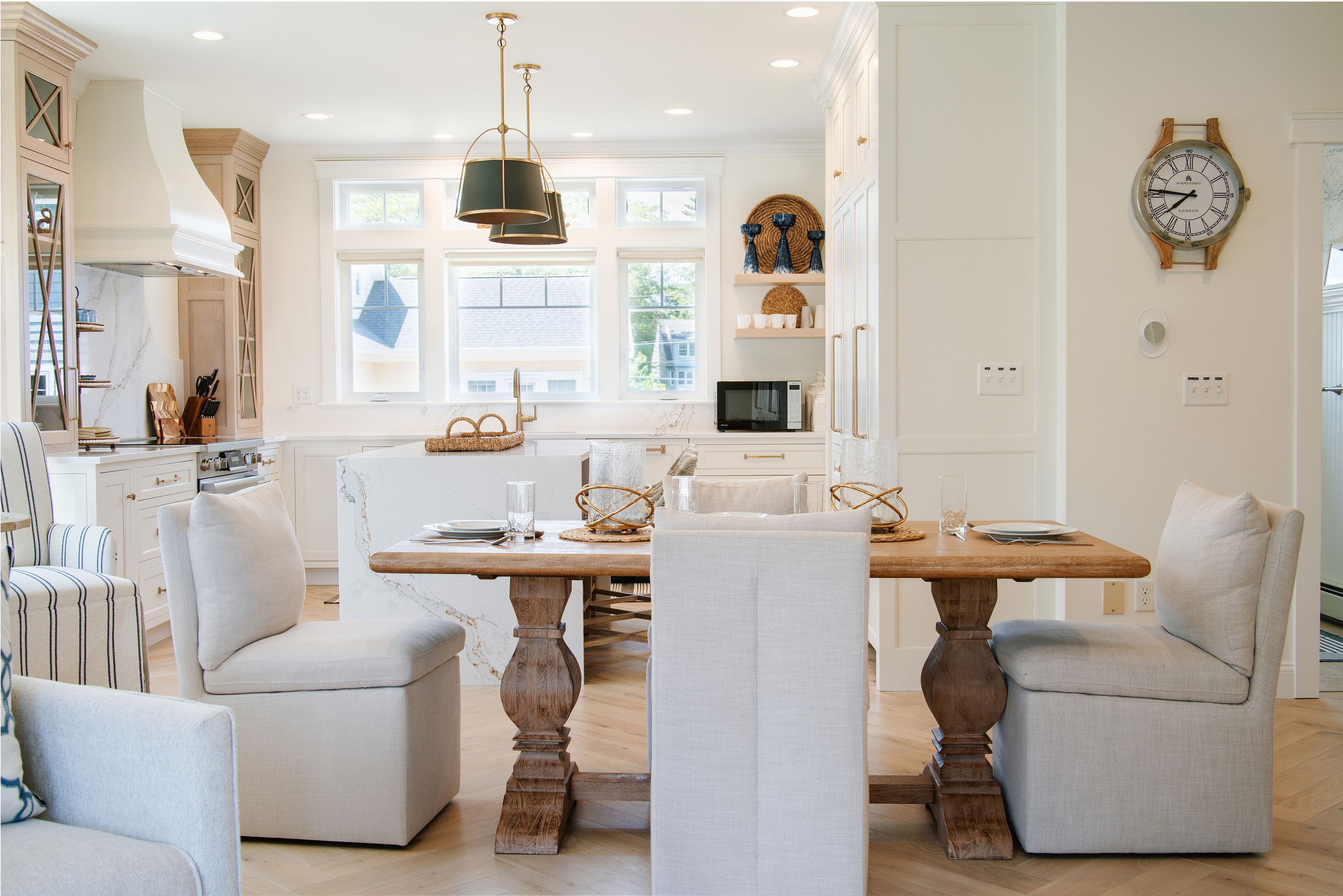 Bright cabinetry, generous workspace, and comfortable seating make this kitchen both stylish and functional.