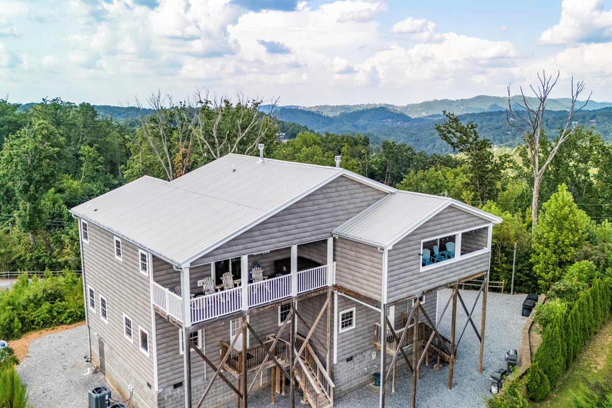 Aerial view of the cabin. The cabin is at the top of Cove Mountain with an amazing view in any direction. The open deck with the white railings on the left is your side.