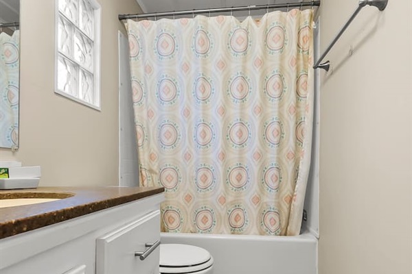 Spacious layout with wood-style flooring and a clean, modern vanity.