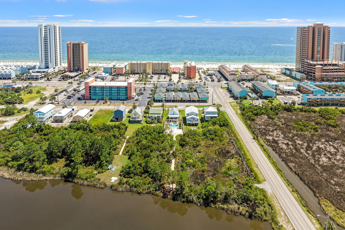 Wide aerial perspective with Little Lagoon on one side and the Gulf of Mexico on the other.