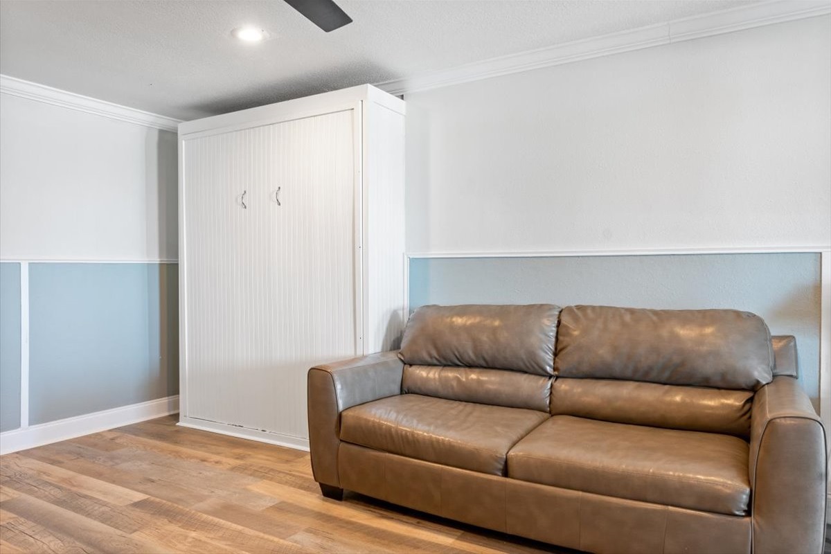 The 1st Floor features another Living Room w/ 50" Smart TV, Pre-Loaded Game Console, Queen Sleeper Sofa, Murphy Bed, a Kitchenette, and Patio Access - Great for the Kids or Two Families!