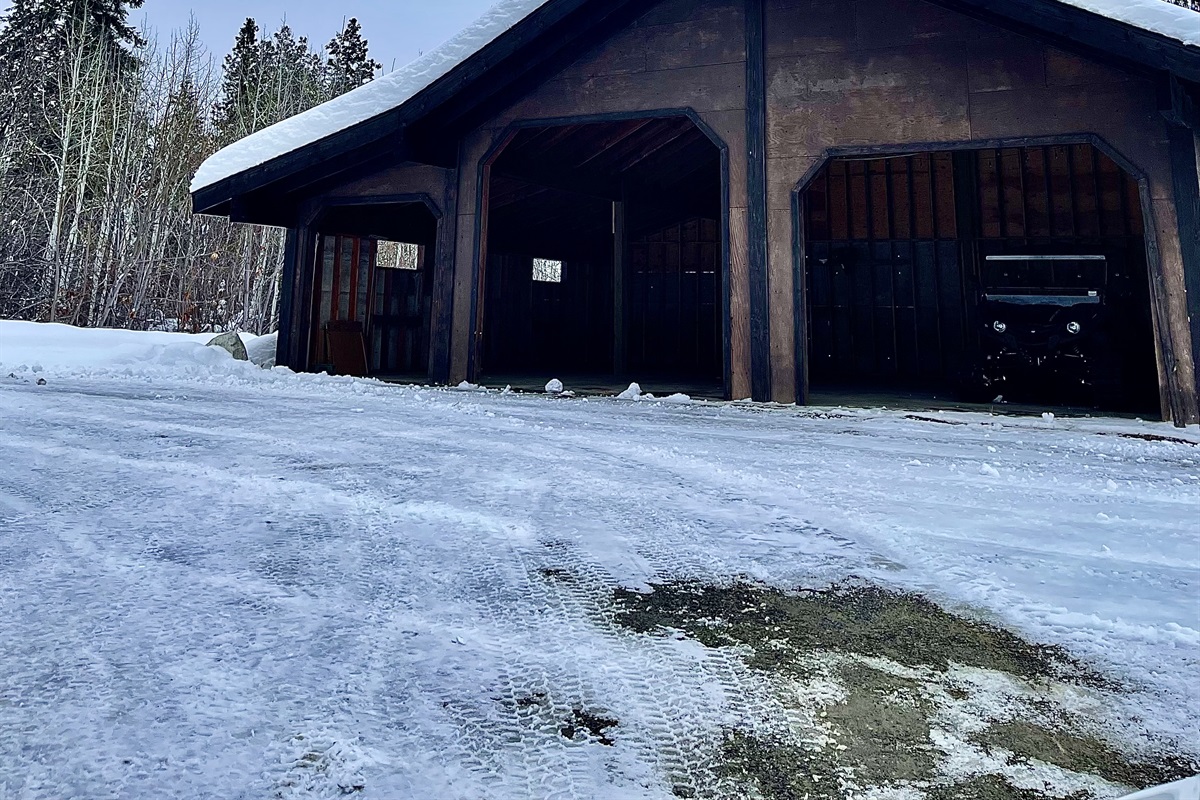 Large outdoor garage at the end of the driveway - perfect for snow mobile trailers!