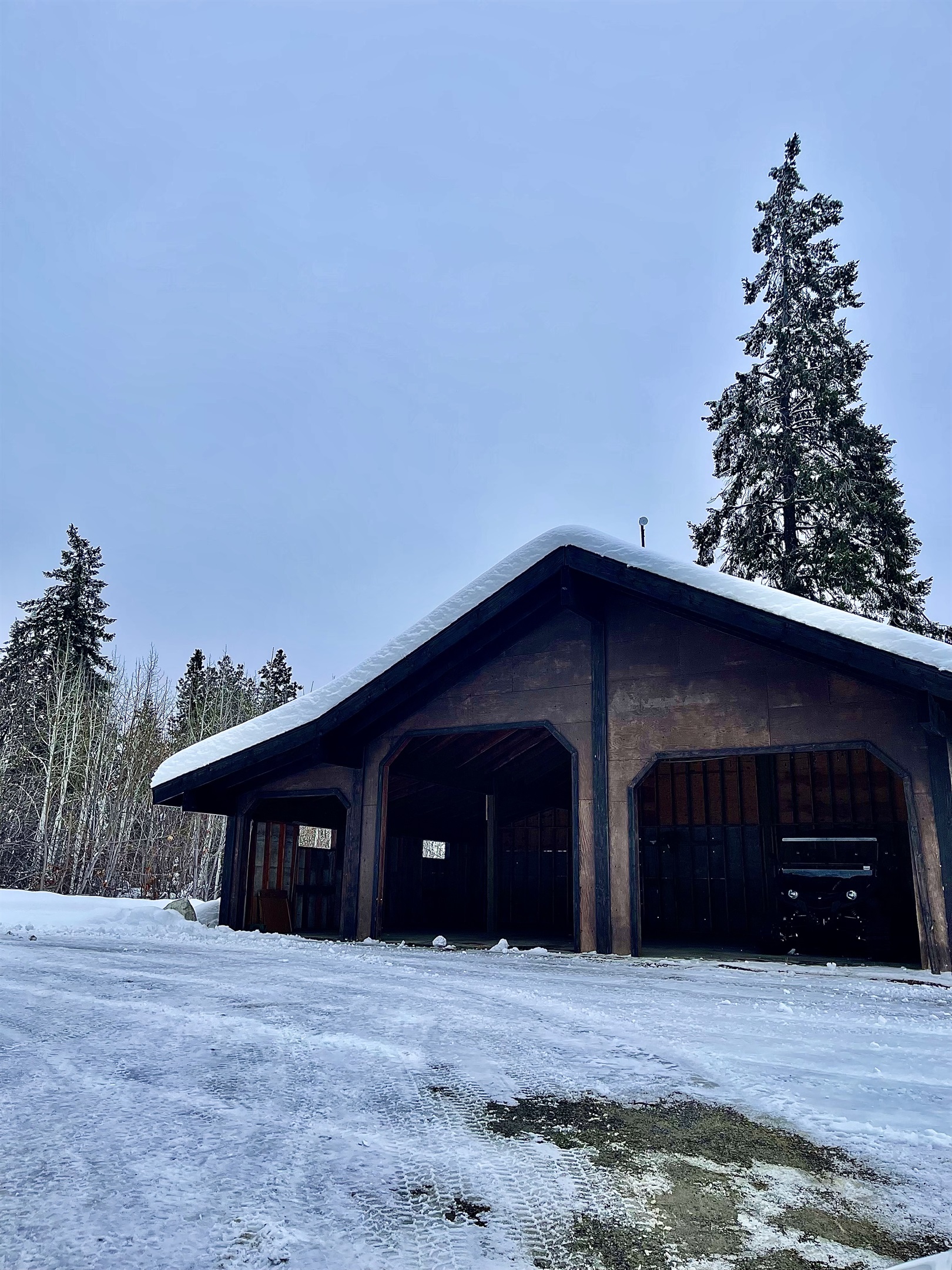 Large outdoor garage at the end of the driveway - perfect for snow mobile trailers!