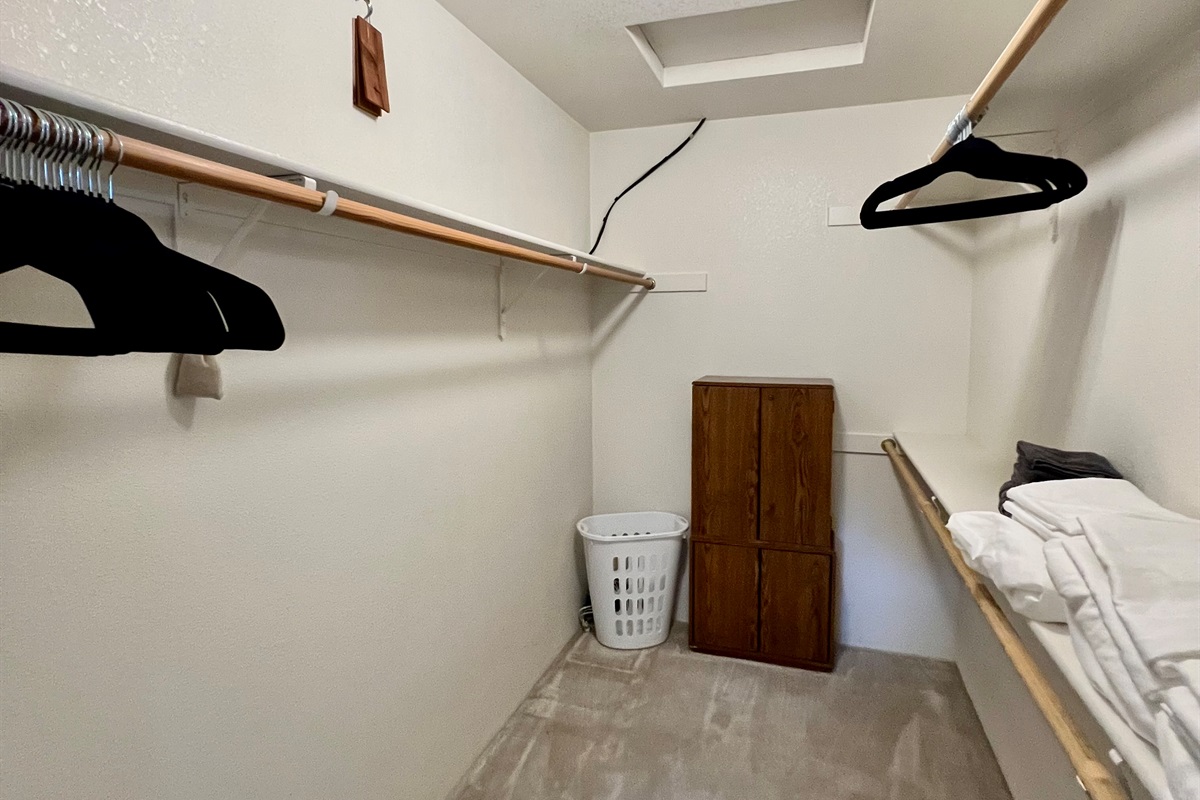 The spacious walk-in closet offers ample hanging space and convenient shelving to keep your belongings organized throughout your stay.