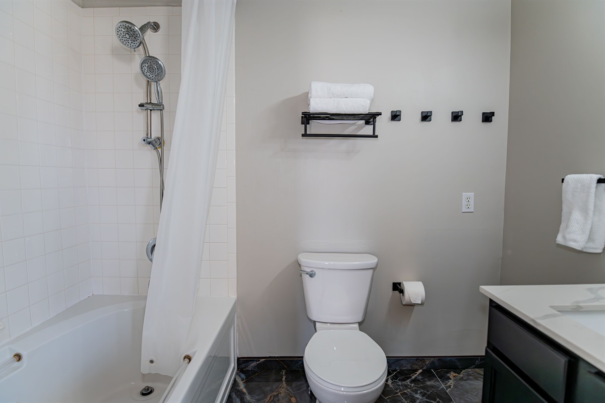 This private ensuite bath pairs perfectly with the cozy queen bedroom - featuring a full tub/shower and everything you need to relax in comfort and style.