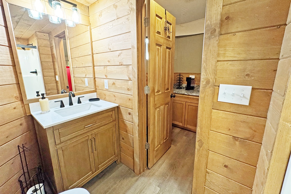 Stylish vanity and warm wood accents create a refreshing oasis for your stay!