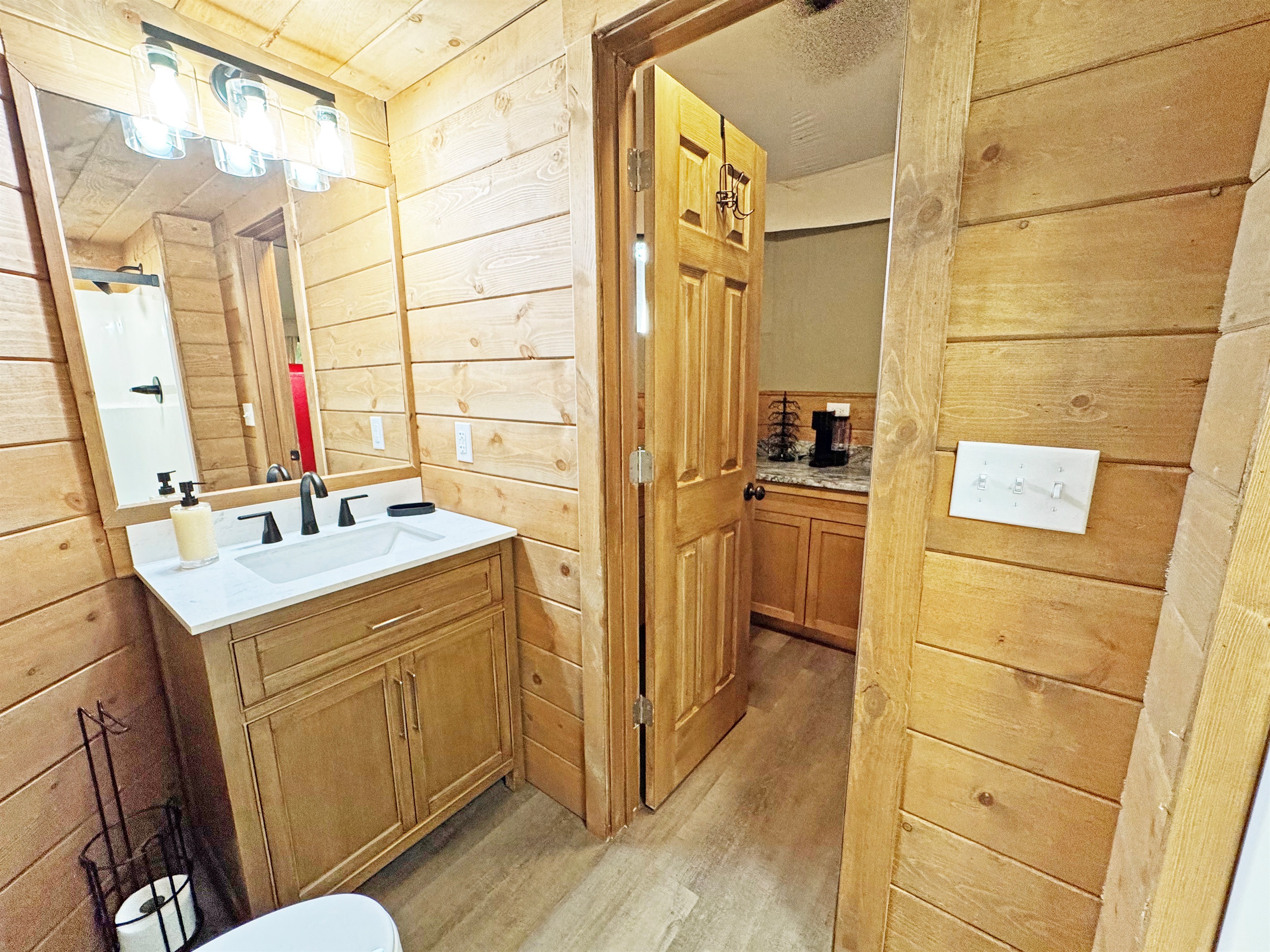Stylish vanity and warm wood accents create a refreshing oasis for your stay!